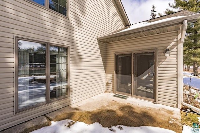 view of snow covered property entrance
