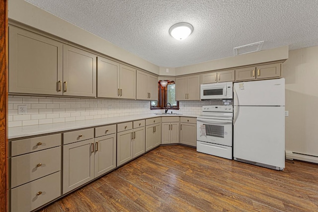 kitchen with a textured ceiling, gray cabinets, a sink, and white appliances