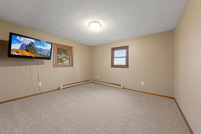 empty room featuring baseboard heating, baseboards, carpet floors, and a textured ceiling