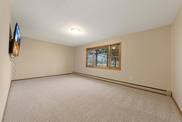 empty room featuring light colored carpet, a baseboard heating unit, and baseboards