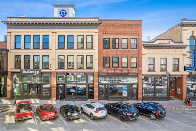 view of building exterior featuring uncovered parking