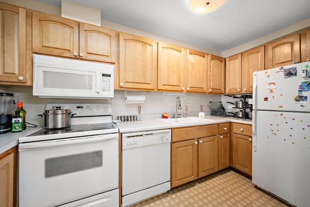 kitchen featuring a sink, light countertops, white appliances, and light floors