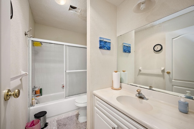 bathroom featuring vanity, enclosed tub / shower combo, tile patterned flooring, a textured ceiling, and toilet