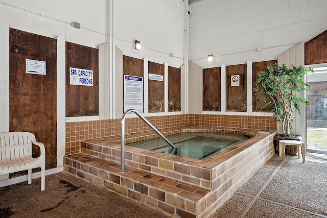 view of swimming pool featuring an indoor hot tub