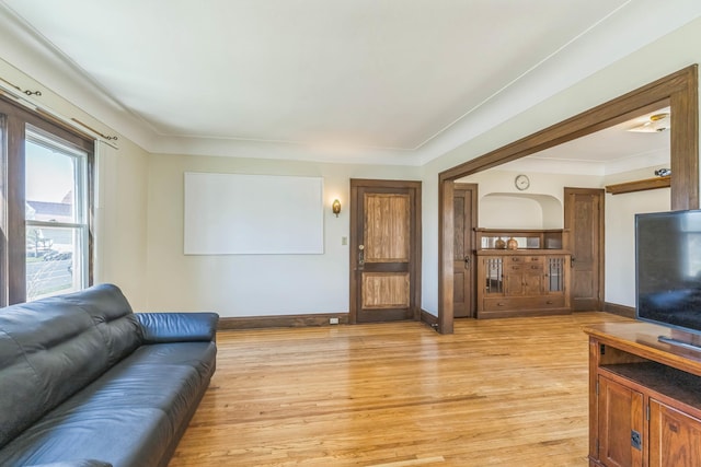living area with light wood finished floors and baseboards