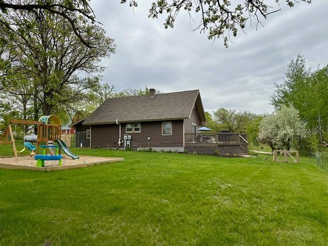 12787 Lumberjack Rd NW, Shevlin, MN 56676 - rear view of house featuring a deck, a yard, and a chimney