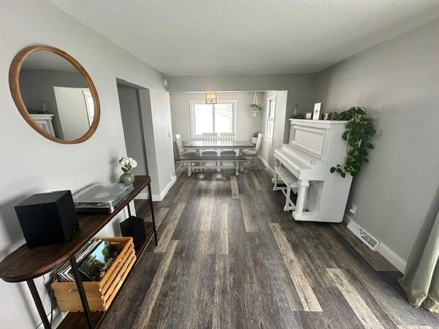 12787 Lumberjack Rd NW, Shevlin, MN 56676 - corridor featuring dark wood-style flooring, a textured ceiling, and baseboards
