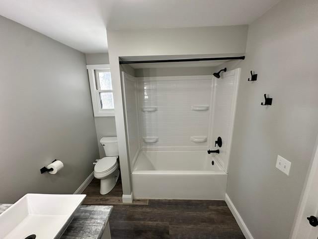 12787 Lumberjack Rd NW, Shevlin, MN 56676 - full bathroom with wood finished floors, toilet, baseboards, vanity, and bathtub / shower combination