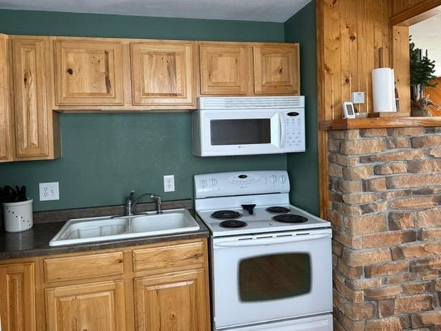 12787 Lumberjack Rd NW, Shevlin, MN 56676 - kitchen with white appliances, a sink, and dark countertops