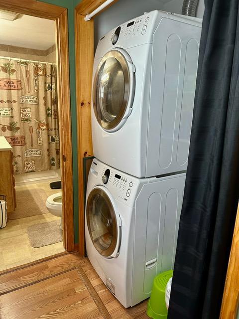 12787 Lumberjack Rd NW, Shevlin, MN 56676 - laundry room featuring stacked washer and clothes dryer and light wood-type flooring
