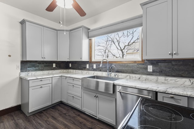3301 Yosemite Ave S, Saint Louis Park, MN 55416 - kitchen with gray cabinetry, dark wood-style floors, a sink, decorative backsplash, and dishwasher