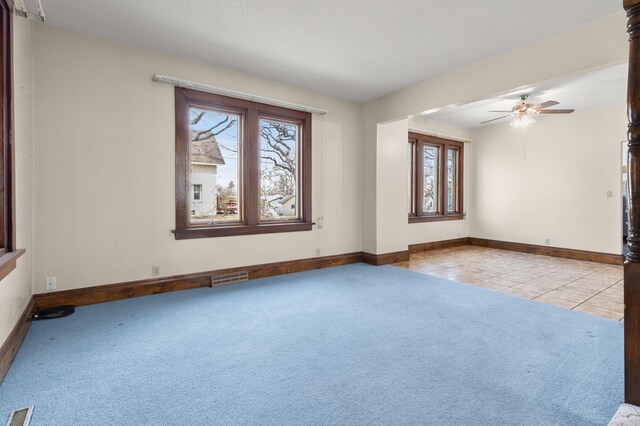 3301 Yosemite Ave S, Saint Louis Park, MN 55416 - carpeted spare room featuring healthy amount of natural light, a ceiling fan, baseboards, and tile patterned flooring