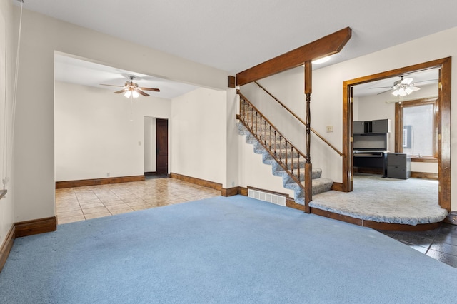 3301 Yosemite Ave S, Saint Louis Park, MN 55416 - unfurnished living room with a ceiling fan, tile patterned flooring, stairs, and carpet flooring