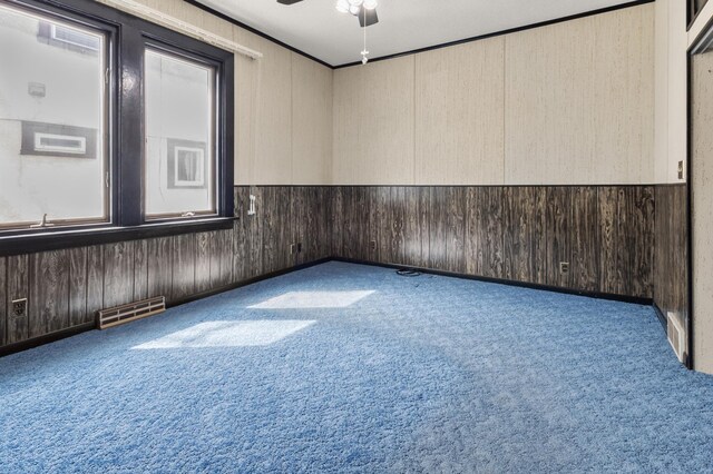 3301 Yosemite Ave S, Saint Louis Park, MN 55416 - carpeted spare room with ceiling fan and wooden walls