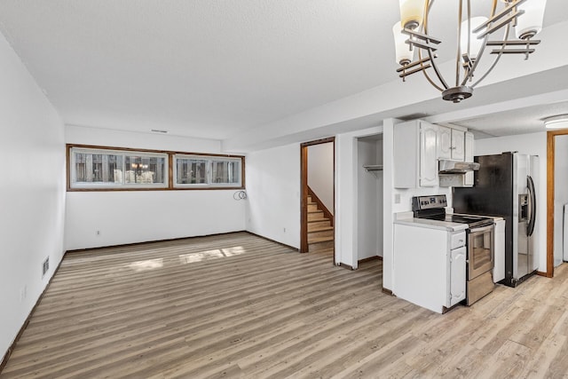 184 Baker St E, Saint Paul, MN 55107 - kitchen with stainless steel appliances, under cabinet range hood, white cabinetry, light countertops, and light wood-style floors