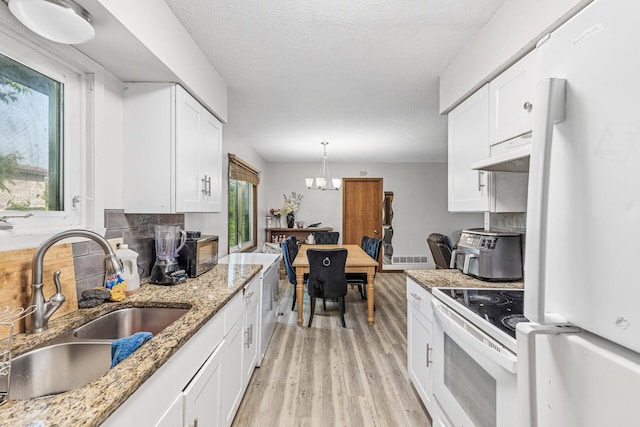 184 Baker St E, Saint Paul, MN 55107 - kitchen featuring white appliances, a sink, under cabinet range hood, light wood-style flooring, and white cabinets