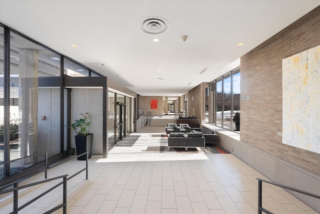 17 1st St Unit A601, Minneapolis, MN 55401 - common area featuring brick wall and floor to ceiling windows