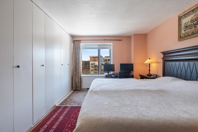 17 1st St Unit A601, Minneapolis, MN 55401 - bedroom featuring dark colored carpet and a textured ceiling