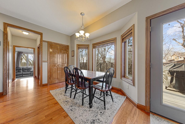 567 Forest Ln, Medford, MN 55049 - dining room featuring a wealth of natural light, light wood-style flooring, baseboards, and an inviting chandelier