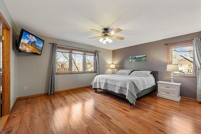 567 Forest Ln, Medford, MN 55049 - bedroom featuring ceiling fan, baseboards, multiple windows, and light wood-type flooring