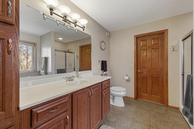 567 Forest Ln, Medford, MN 55049 - full bath with tile patterned flooring, toilet, vanity, baseboards, and a stall shower
