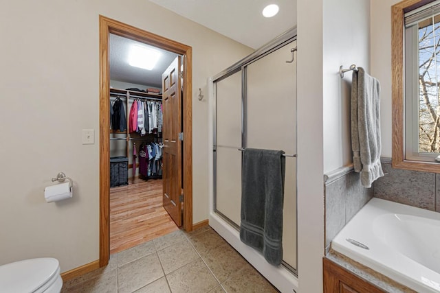 567 Forest Ln, Medford, MN 55049 - bathroom with a bath, tile patterned floors, toilet, a shower stall, and a walk in closet