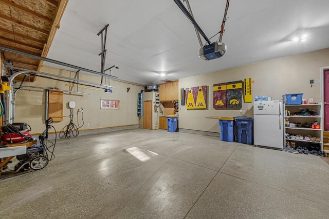 567 Forest Ln, Medford, MN 55049 - garage with freestanding refrigerator and a garage door opener