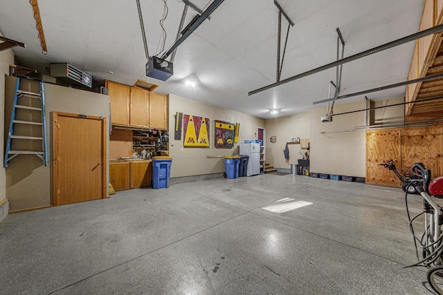 567 Forest Ln, Medford, MN 55049 - garage featuring freestanding refrigerator and a garage door opener