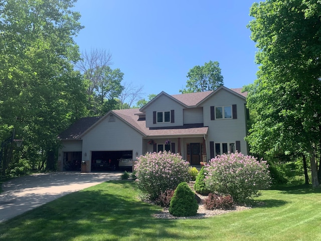 567 Forest Ln, Medford, MN 55049 - traditional home featuring an attached garage, driveway, roof with shingles, and a front yard