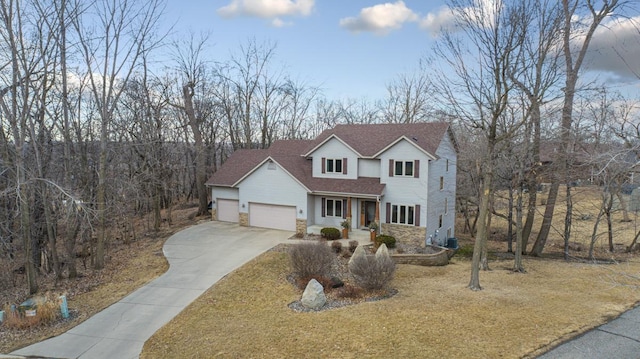 567 Forest Ln, Medford, MN 55049 - traditional home with driveway, stone siding, a shingled roof, an attached garage, and a front yard