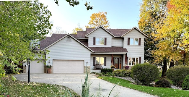 567 Forest Ln, Medford, MN 55049 - traditional-style home with a garage, driveway, a shingled roof, and covered porch