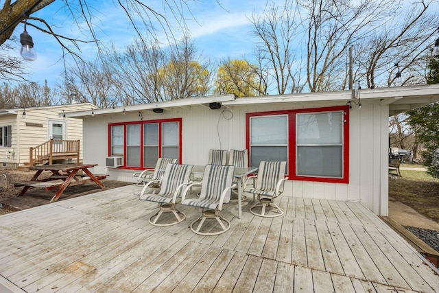 deck with outdoor dining space and cooling unit