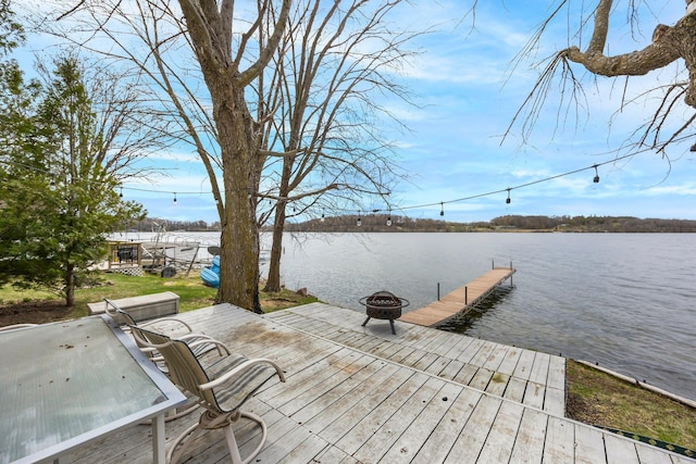 dock area featuring a fire pit and a water view
