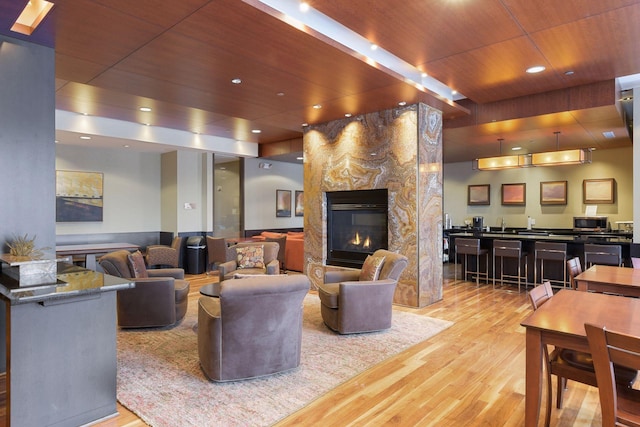 3707 Grand Way Unit 101, Saint Louis Park, MN 55416 - living room featuring wooden ceiling, wood finished floors, a warm lit fireplace, and recessed lighting