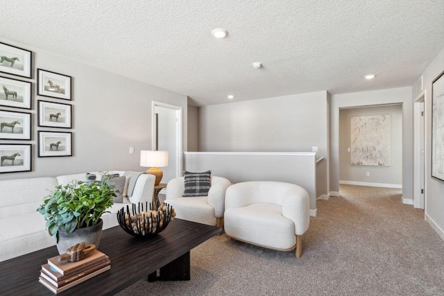 living area with carpet floors, recessed lighting, and a textured ceiling