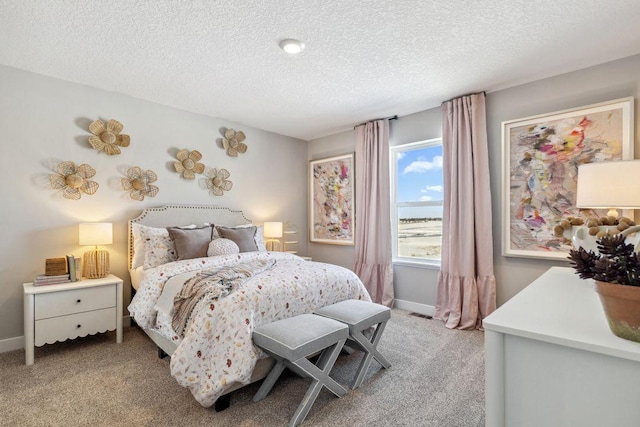bedroom with a textured ceiling, light carpet, and baseboards