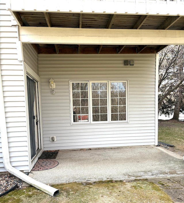 view of exterior entry featuring a patio
