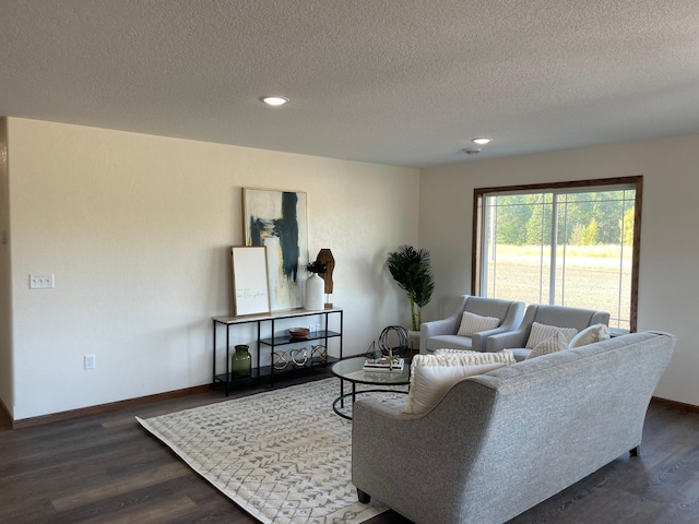 living room featuring a textured ceiling, baseboards, dark wood-style floors, and recessed lighting