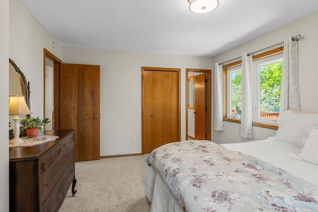 7165 Upper 157th St W, Apple Valley, MN 55124 - bedroom with a closet, light colored carpet, a textured ceiling, and baseboards