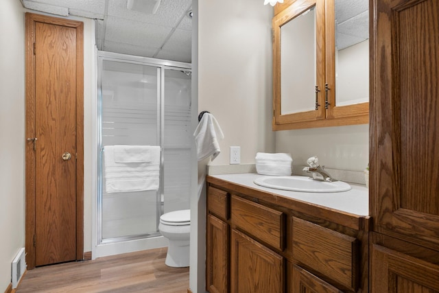 7165 Upper 157th St W, Apple Valley, MN 55124 - bathroom with a stall shower, toilet, wood finished floors, vanity, and a paneled ceiling