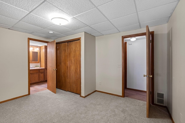 7165 Upper 157th St W, Apple Valley, MN 55124 - unfurnished bedroom featuring light colored carpet, a closet, a drop ceiling, baseboards, and ensuite bathroom