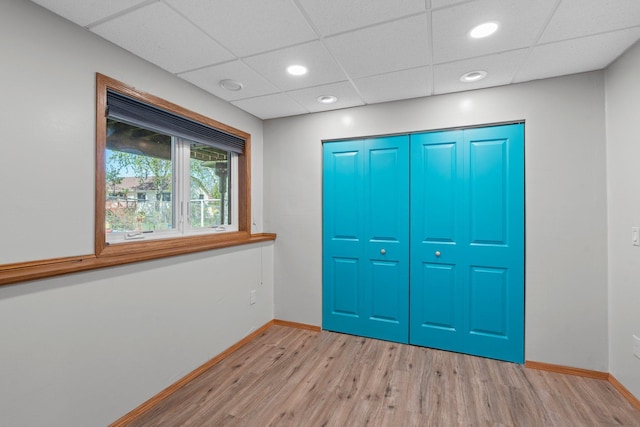 7165 Upper 157th St W, Apple Valley, MN 55124 - unfurnished bedroom with light wood-style floors, baseboards, a closet, recessed lighting, and a paneled ceiling