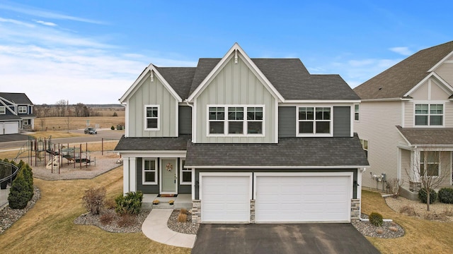 2301 Kester Ave NE, Saint Michael, MN 55376 - view of front of home featuring a front lawn, a shingled roof, board and batten siding, an attached garage, and driveway