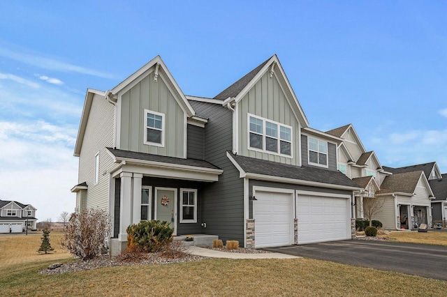 2301 Kester Ave NE, Saint Michael, MN 55376 - view of front facade with board and batten siding, an attached garage, a front yard, and aphalt driveway