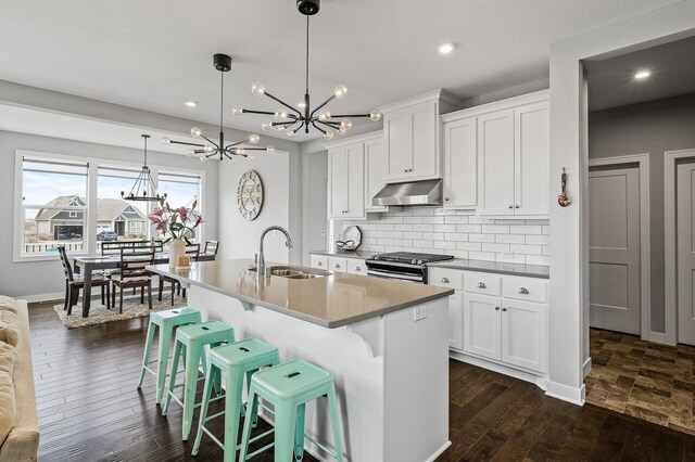 2301 Kester Ave NE, Saint Michael, MN 55376 - kitchen with an inviting chandelier, stainless steel gas range oven, recessed lighting, under cabinet range hood, and a sink
