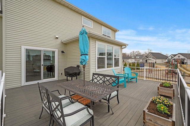 2301 Kester Ave NE, Saint Michael, MN 55376 - wooden deck featuring outdoor dining area, a playground, and a residential view