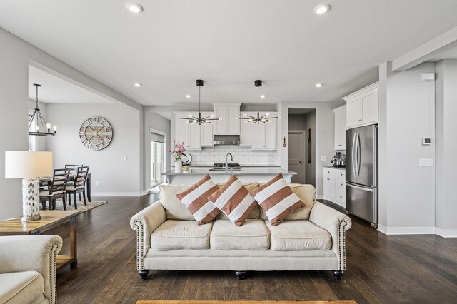 2301 Kester Ave NE, Saint Michael, MN 55376 - living area featuring an inviting chandelier, recessed lighting, baseboards, and dark wood-type flooring