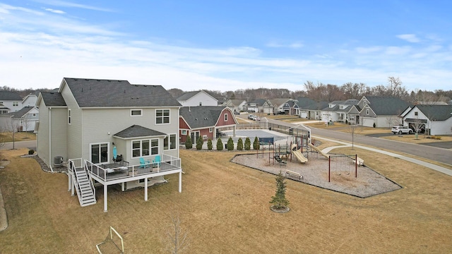 2301 Kester Ave NE, Saint Michael, MN 55376 - rear view of property featuring a deck, a residential view, stairway, a playground, and a yard