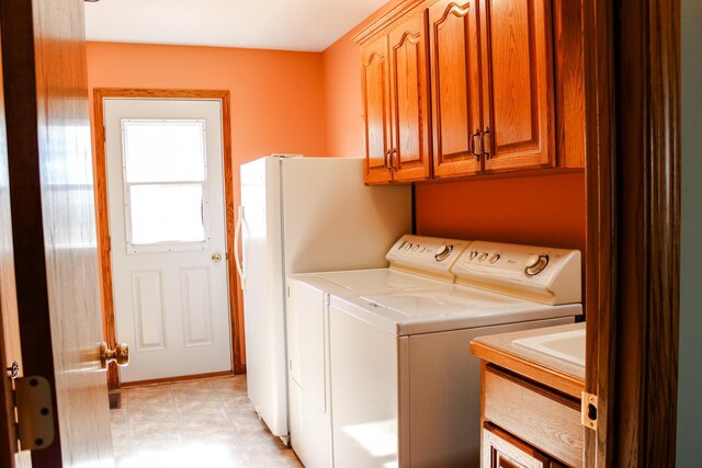 46377 Sunset Ct, Morris, MN 56267 - laundry area with independent washer and dryer and cabinet space