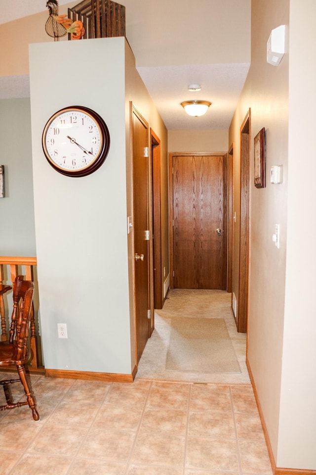 46377 Sunset Ct, Morris, MN 56267 - corridor with baseboards and light tile patterned flooring